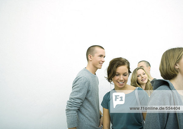 Group of young adult and teenage friends  white background