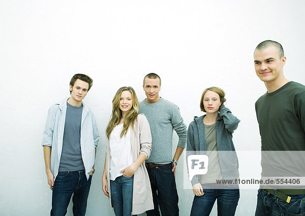 Group of young adult and teenage friends  white background