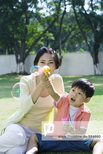 Mother and son making bubbles
