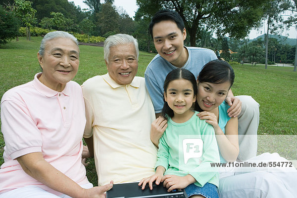 Three generation family  smiling at camera