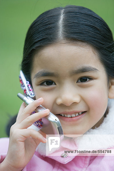 Little girl using cell phone  close-up