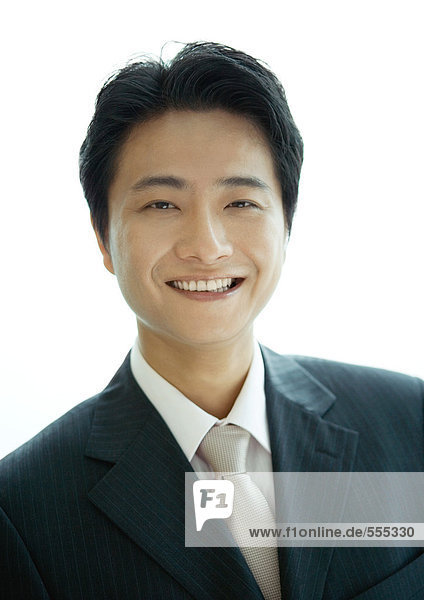 Businessman smiling at camera  portrait  white background