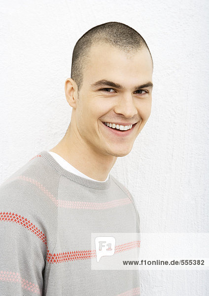 Young man smiling at camera  portrait