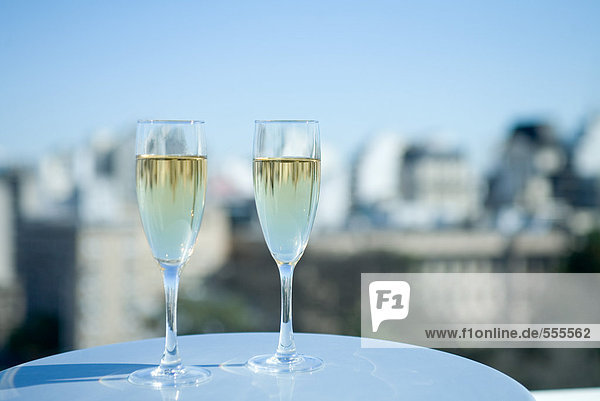 Two glasses of champagne and city skyline