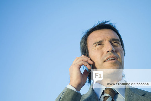 Businessman using cell phone  low angle view