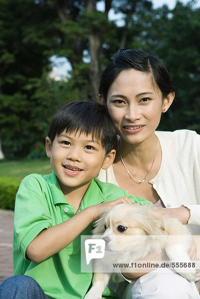 Mother and son with dog  portrait