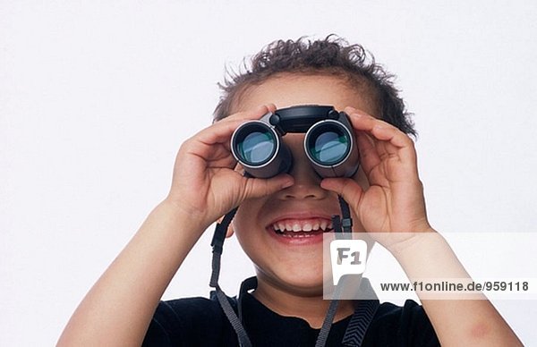 Young boy  smiling  with binoculars