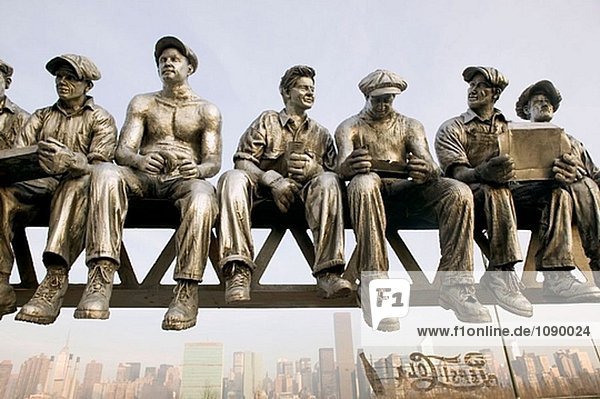 Eisen Arbeitnehmer Skulptur von Sergio Furnari und Blick auf die New York Stadt. Long Island City. Queens. New York City. USA.