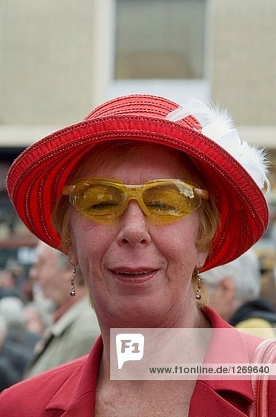 60 years old red dressed lady at a street party Spielbudenplatz. St. Pauli. Hamburg. Germany