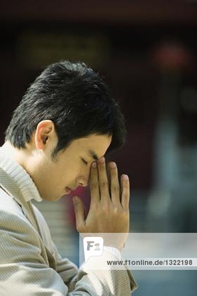 Junger Mann betend