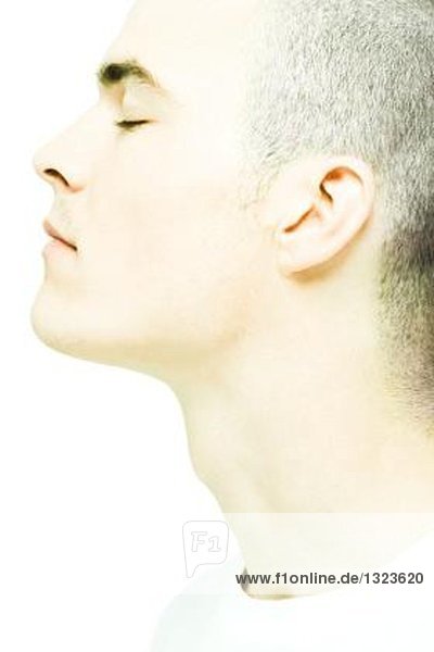 Young man with eyes closed  close-up of face and neck  profile