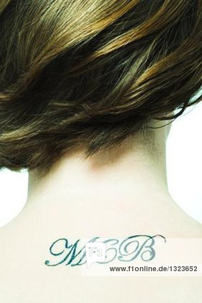 Initials tattooed on teenage girl's back