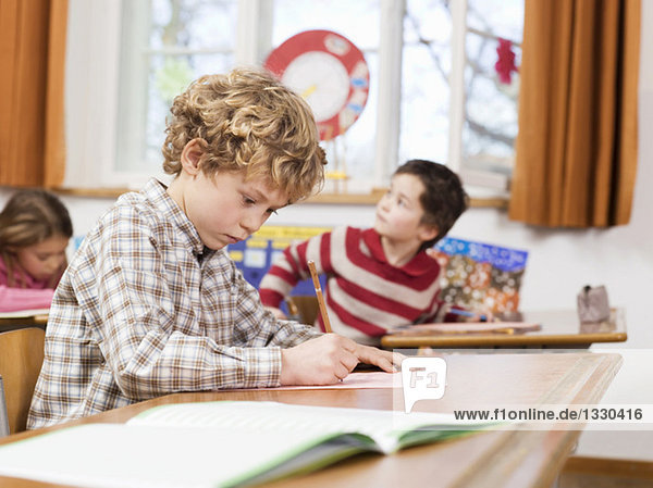 Kinder (4-7) Schreibprüfung im Klassenzimmer  Schwerpunkt Junge