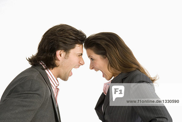 Businessman and businesswoman shouting at each other  side view