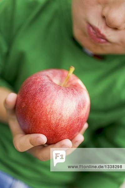 Child eating a Gala apple