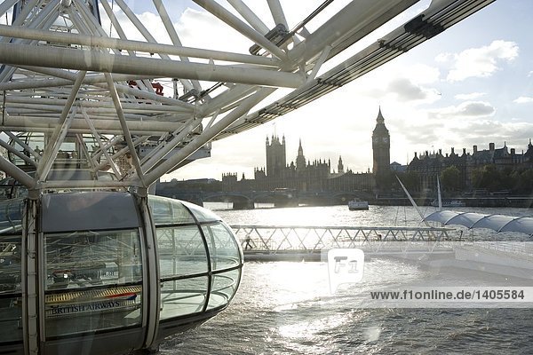 Ferris wheel with government building in background  Millennium Wheel  Thames River  Big Ben  Houses Of Parliament  City Of Westminster  London  England