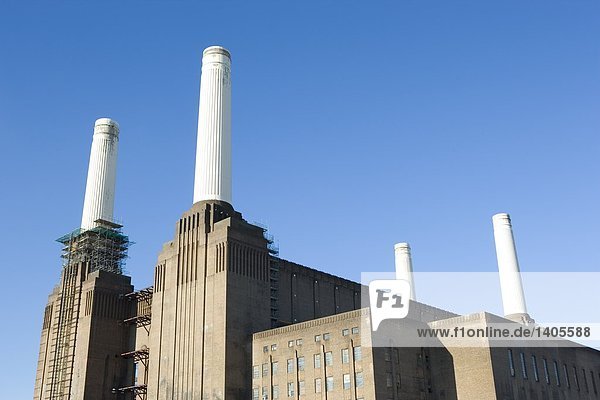Low angle view of power station against clear blue sky  Battersea Power Station  London  England
