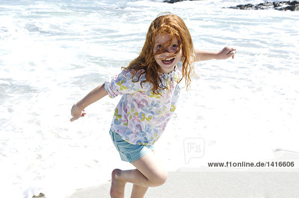 Little girl walking on the beach  outdoors