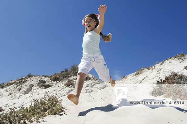 Little girl running on the beach  outdoors