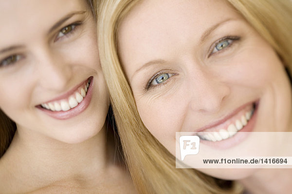 Portrait of two women smiling for the camera  indoors