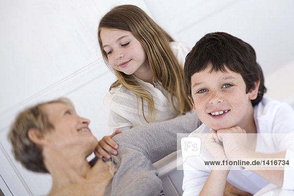 Senior woman with two children  indoors