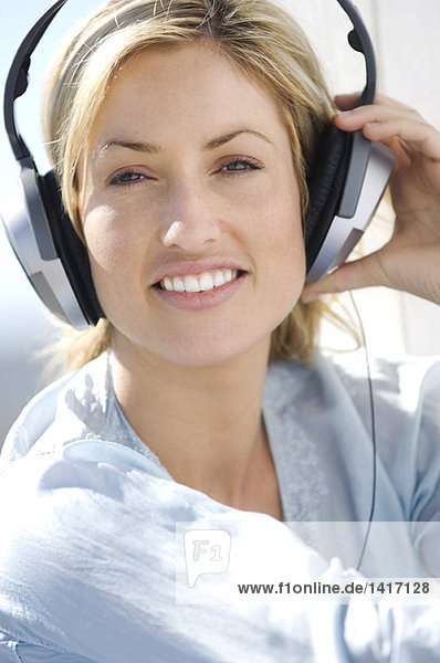 Portrait of a young woman  listening to music with headphones