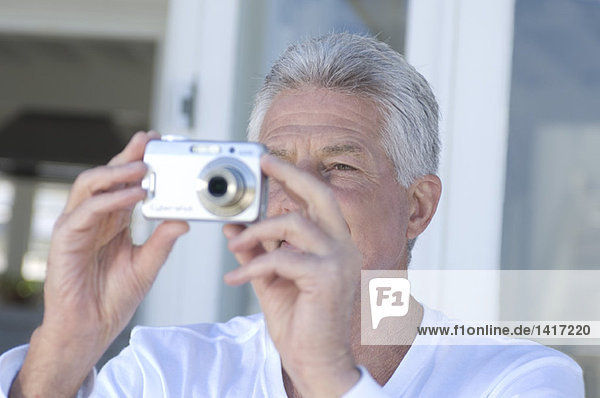 Portrait of a man using digital camera