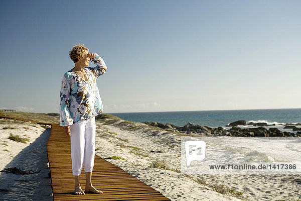 Senior woman looking out to sea