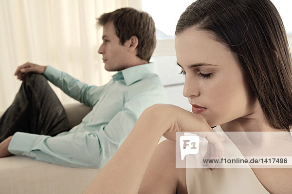 Couple sulking in living-room