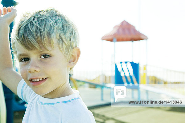 Boy on playground  smiling at camera
