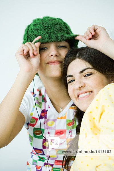Two young female friends  smiling at camera