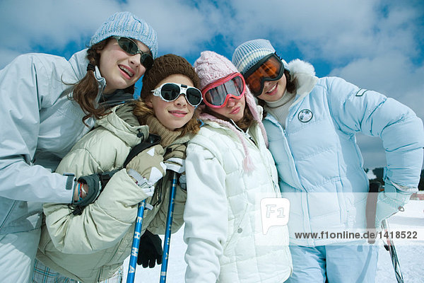 Young skiers standing on ski slope  portrait
