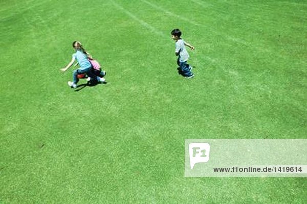 Kinder beim Ballspielen auf Rasen