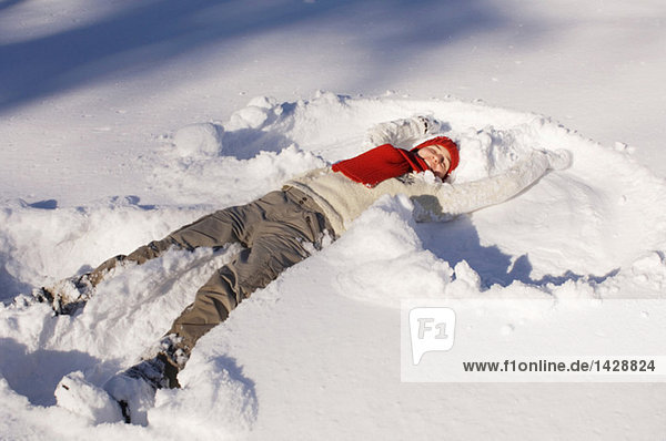 Woman lying in snow