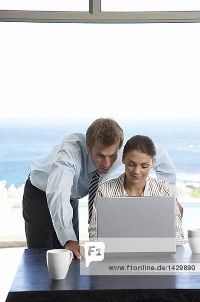Man and woman working at laptop
