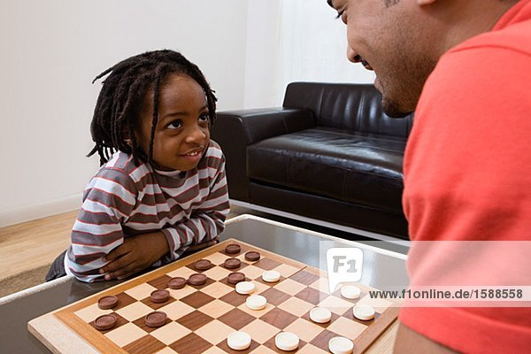 Father and son playing draughts
