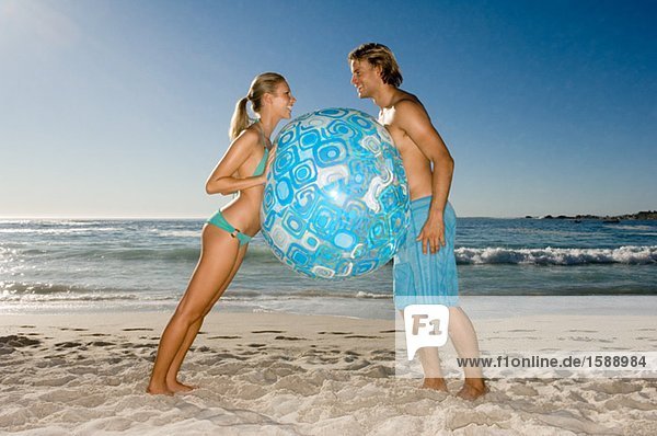 Couple holding beach ball