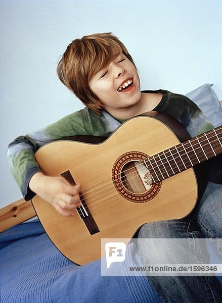 Ein kleiner Junge Gitarre zu spielen.