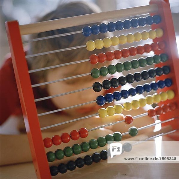 Boy using abacus.
