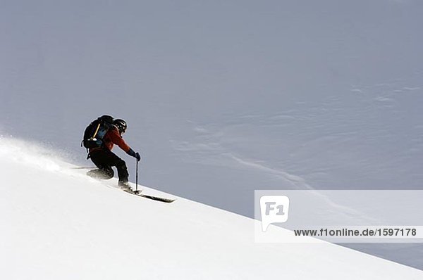 Alpine skier going downhill.