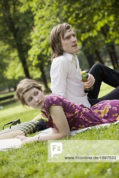 Young Scandinavian couple on a lawn Sweden.