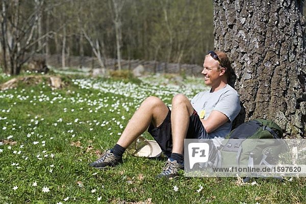 Man resting by a tree Boras Sweden.