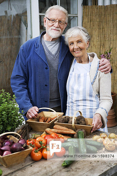 An elderly Scandinavian couple with vegetables in front of them Sweden.