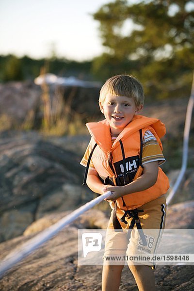 A Scandinavian boy holding on to a ropes end Sweden.