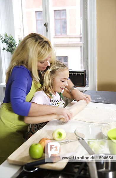 A mother and her daughter baking together Sweden.