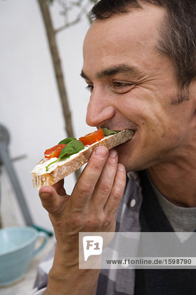 A man eating a sandwich.
