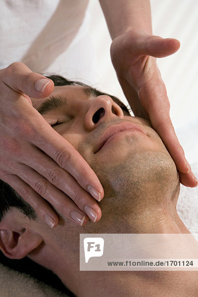 Man receiving facial massage
