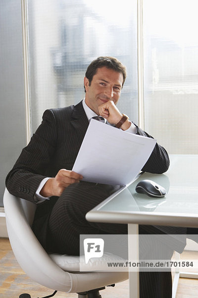 Business man reading papers  portrait