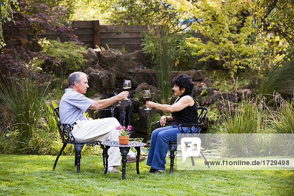 Couple Enjoying Wine in Backyard