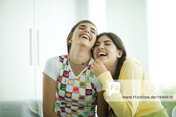 Young female friends laughing mouth